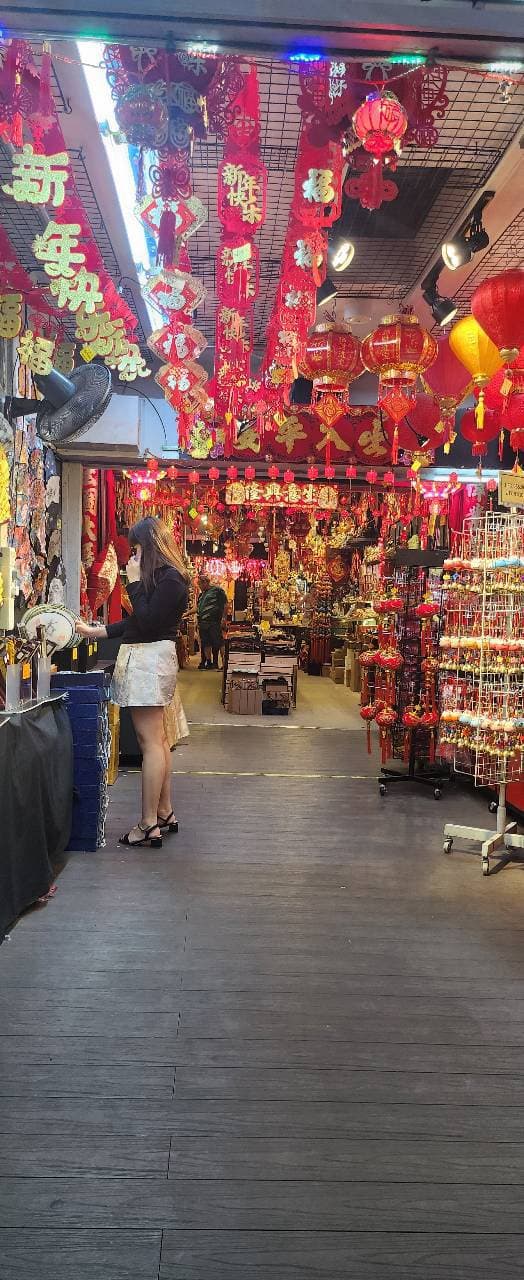 A Chinatown shop packed with red lanterns and New Year decorations hanging from the ceiling.